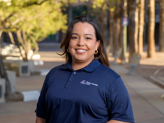 Image of TCC program coordinator standing outdoors in navy blue uniform shirt