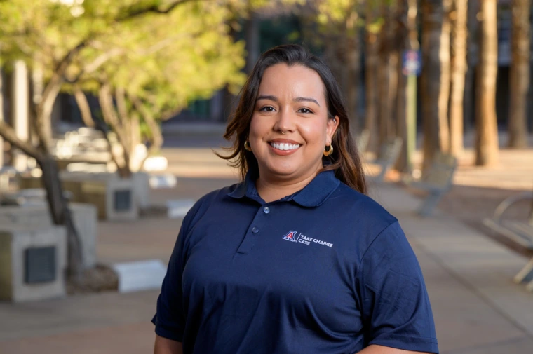 Image of TCC program coordinator standing outdoors in navy blue uniform shirt